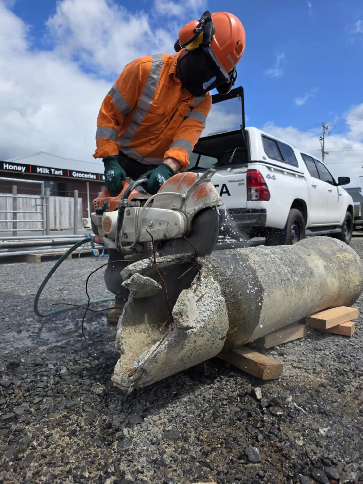 A concrete saw cutting a road surface